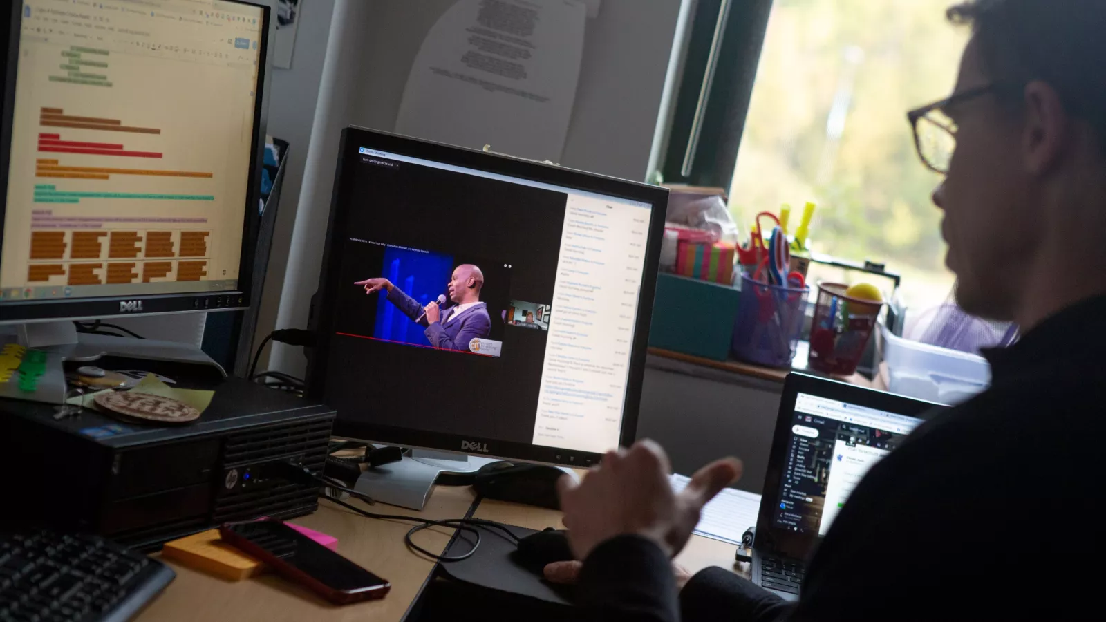 A social studies teacher participates in an online staff meeting alone in his classroom at Middletown High School.