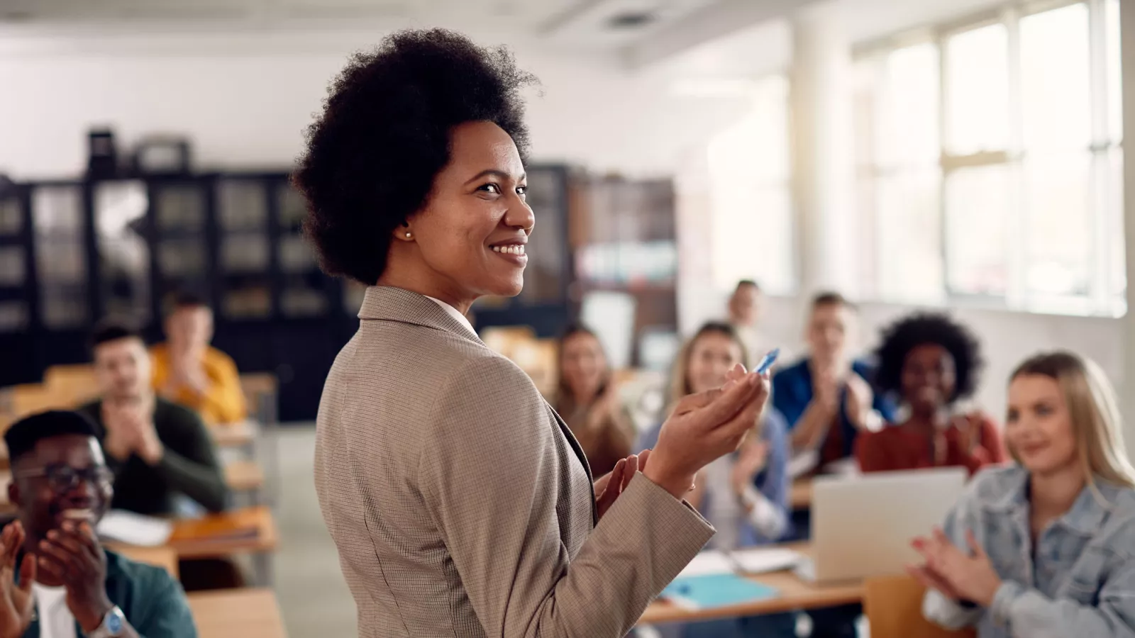 black woman teaches in a classoom