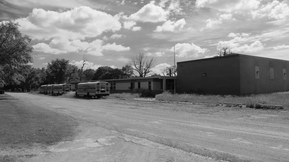 a black and white photo of an abandoned rural school