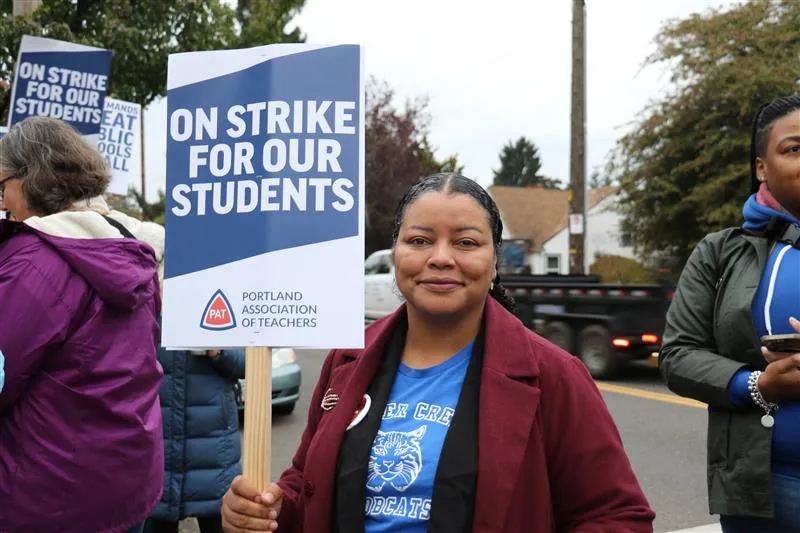 OEA Equity Director Monica Weathersby hold a PAT strike sign