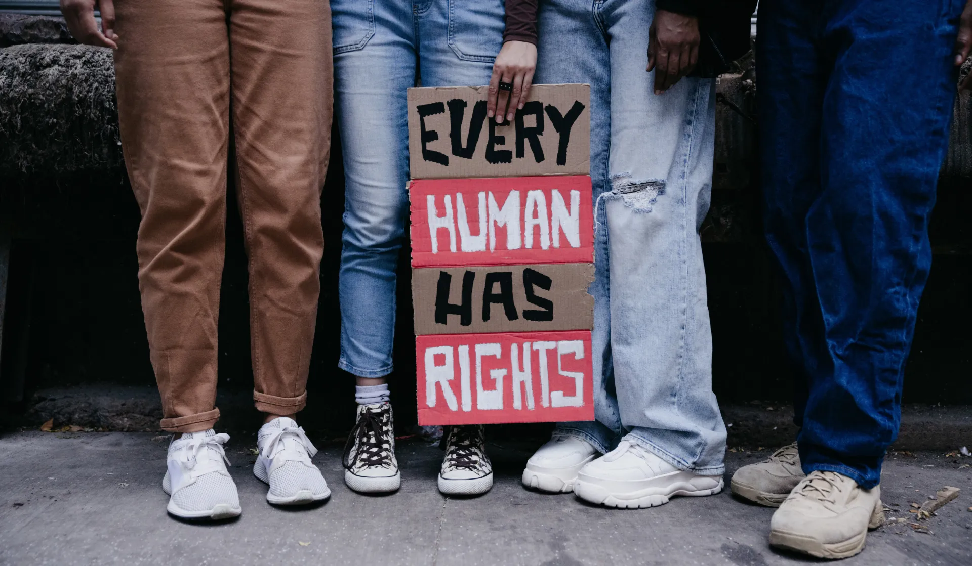 Group of students holding sign that reads "Every Human Has Rights"