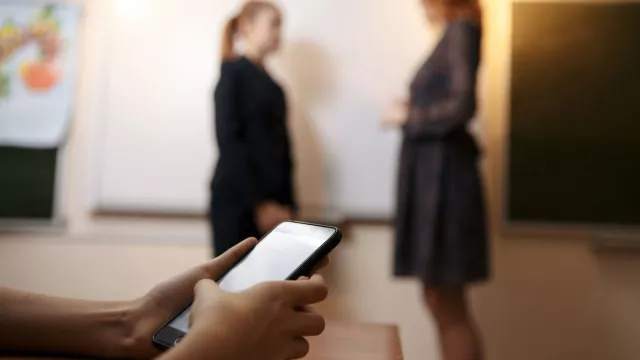 A cell phone with people in the distance